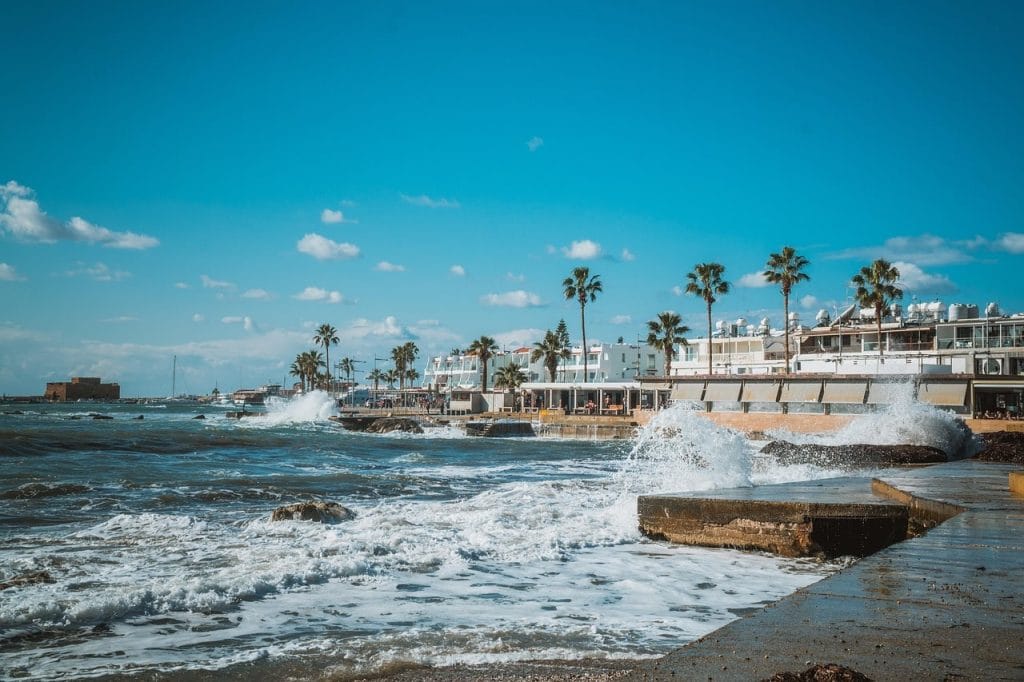 mar, olas y pueblo de casas blancas